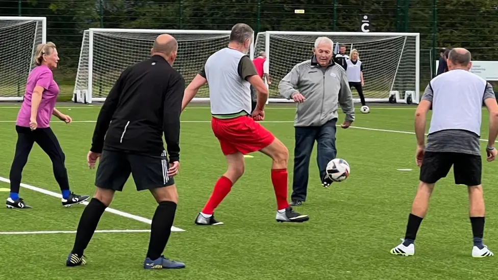 Football players with Parkinson's are empowering - A football manager says it is "empowering" to watch a team of people with Parkinson's disease playing the game.
Nigel Osmond manages around 20 walking football players at Portishead Town FC who are getting ready for their first fixture on Saturday.
The sport allows some players to do more on the pitch than their symptoms would allow them to do off it, participants say, and also helps them socialise.